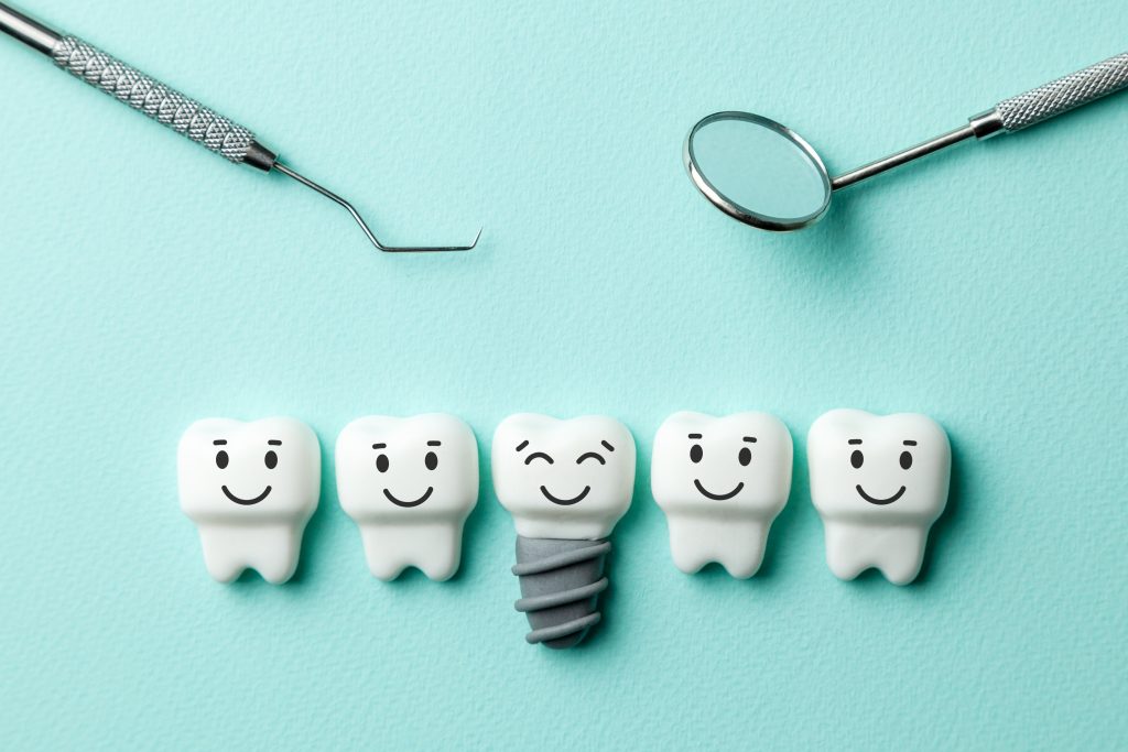 healthy white teeth and implants are smiling against green mint